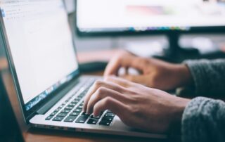 Someone studying for their real estate exams in Ontario with a laptop